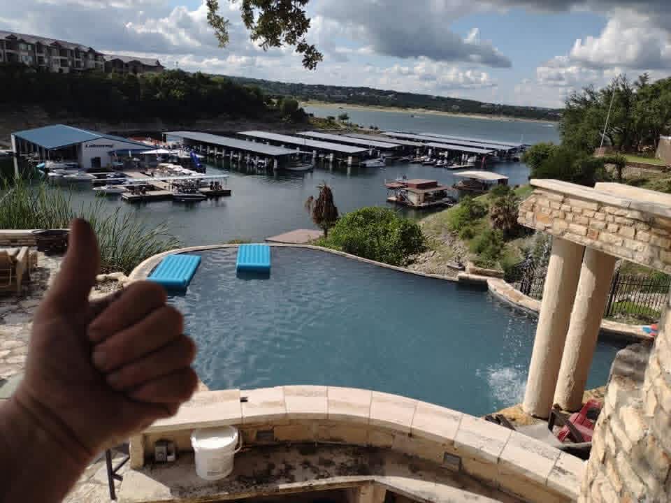 Lakeway infinity pool overlooking Lake Travis marina — weekly service by The Pool Police