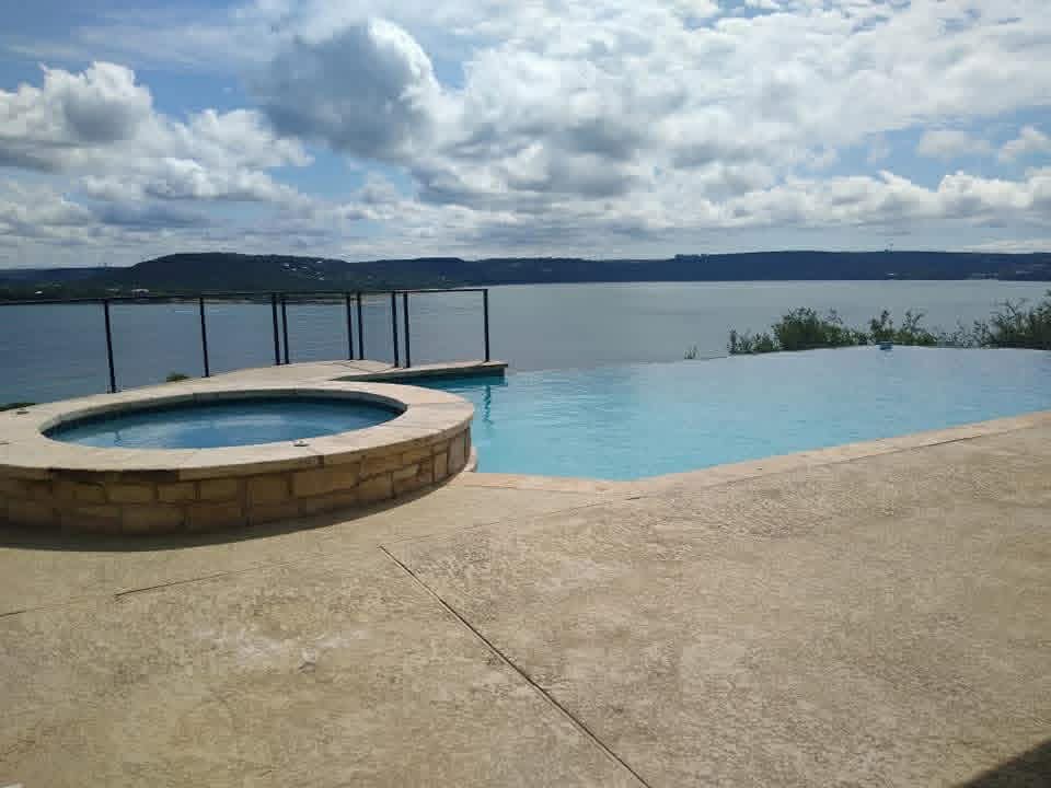 Infinity-edge pool overlooking Lake Travis — premium weekly maintenance by The Pool Police, Lakeway TX