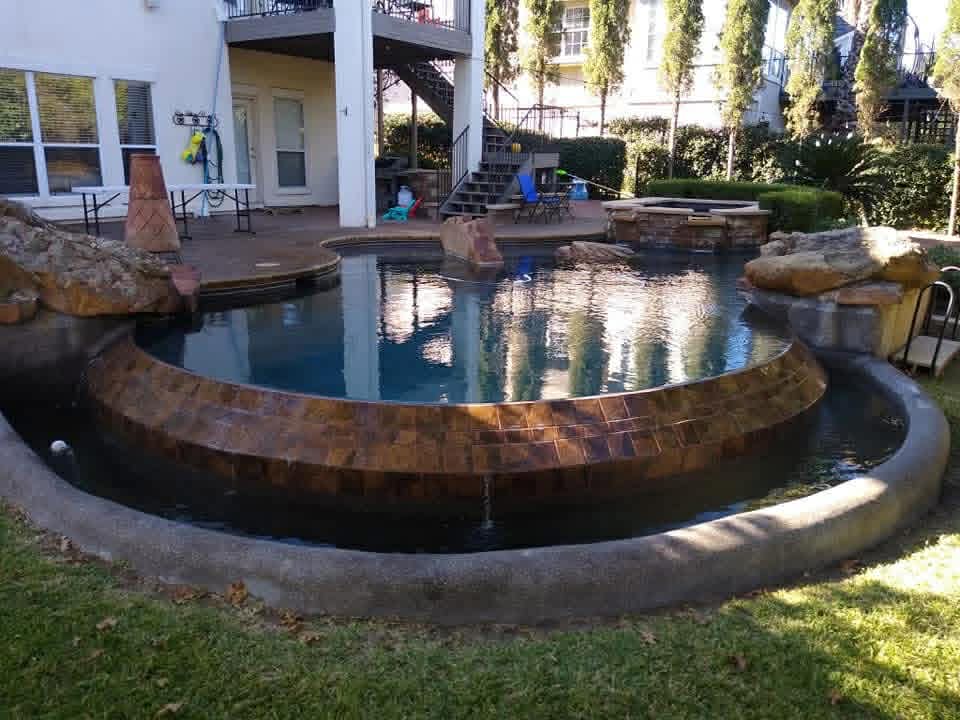 Pool with copper-tile waterfall feature — premium pool maintenance by The Pool Police, Austin TX